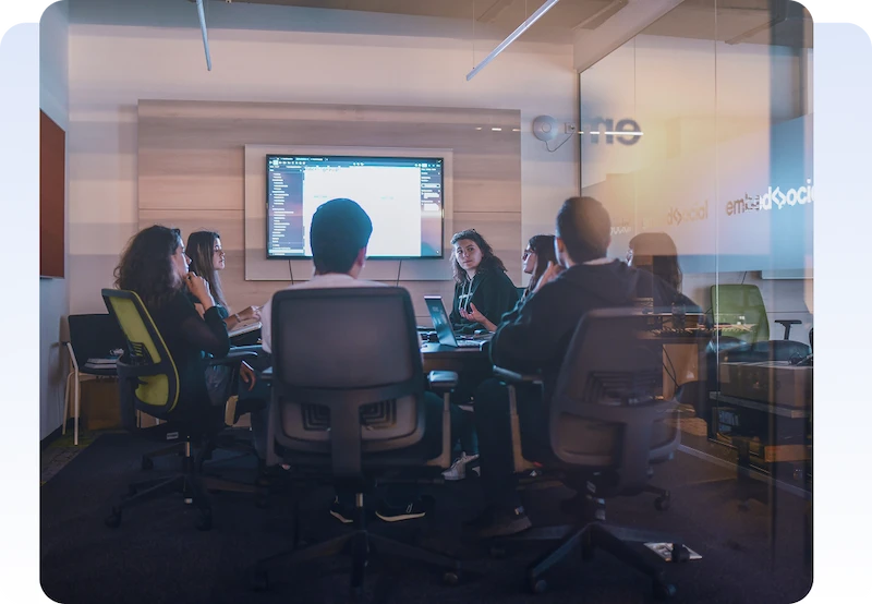 Team collaborating during a meeting in a modern conference room.